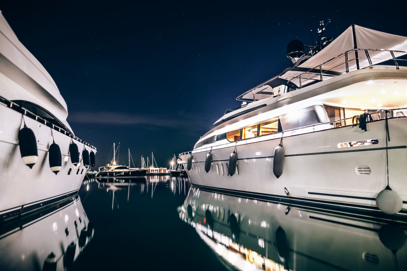 Two luxury yachts in a harbour.